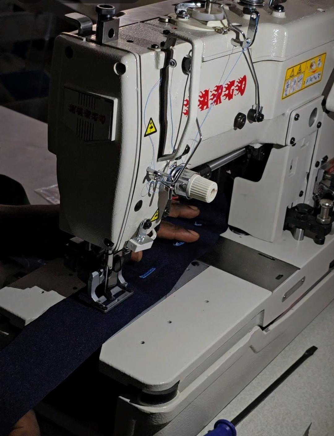 Industrial apparel production machine in the workshop
