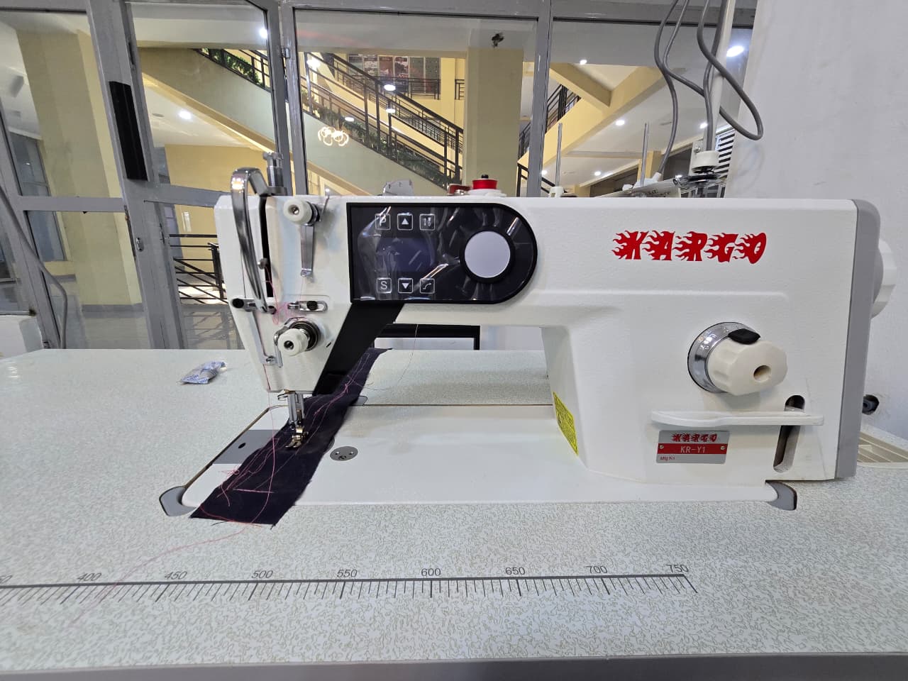 Side view of a garment-making machine at work